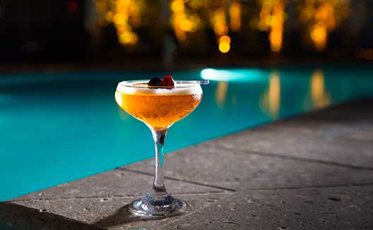cocktail by the pool at night